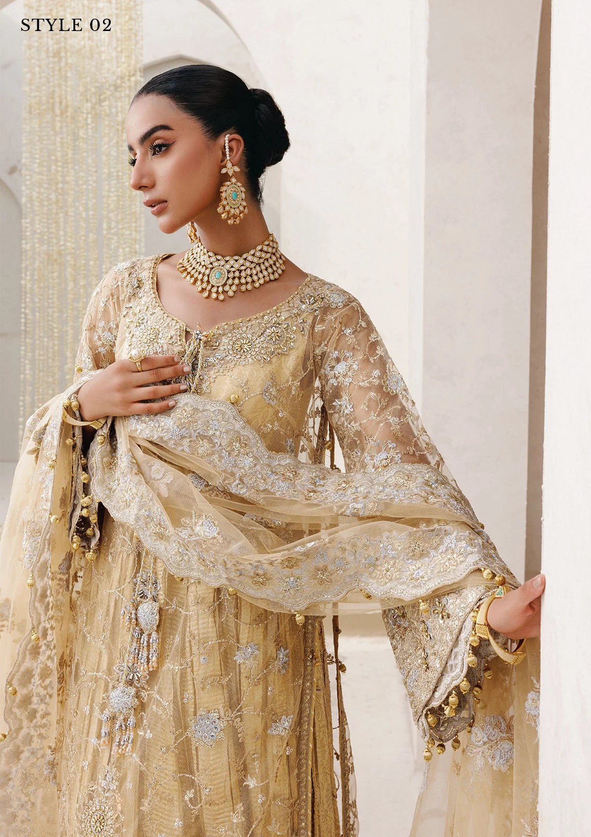 Elegant embroidered net ensemble with tissue neckline, rich borders, jamawar pants, and an embroidered net dupatta. Styled as a long shirt with farshi gharara or side-slit long shirt with crushed frock.