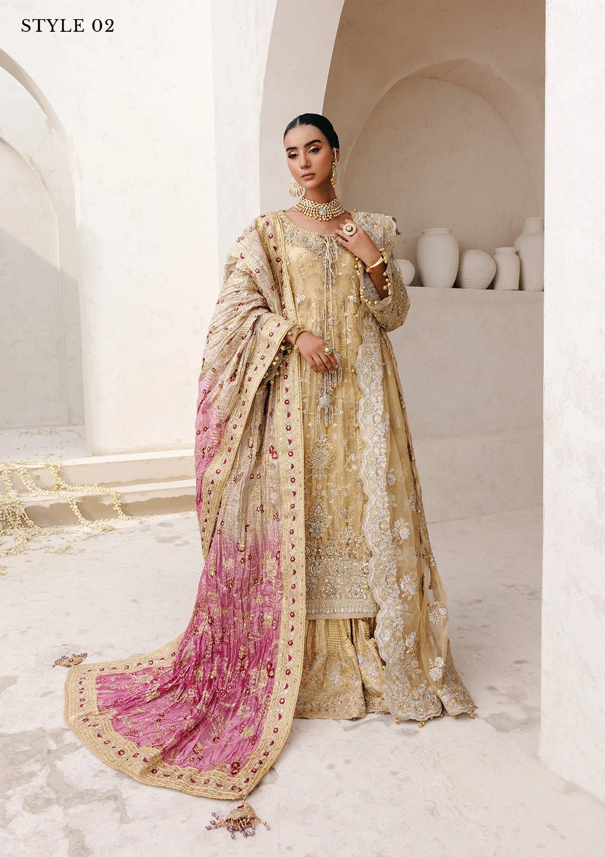 Elegant embroidered net ensemble with tissue neckline, rich borders, jamawar pants, and an embroidered net dupatta. Styled as a long shirt with farshi gharara or side-slit long shirt with crushed frock.