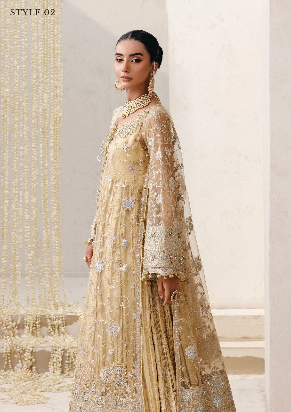 Elegant embroidered net ensemble with tissue neckline, rich borders, jamawar pants, and an embroidered net dupatta. Styled as a long shirt with farshi gharara or side-slit long shirt with crushed frock.