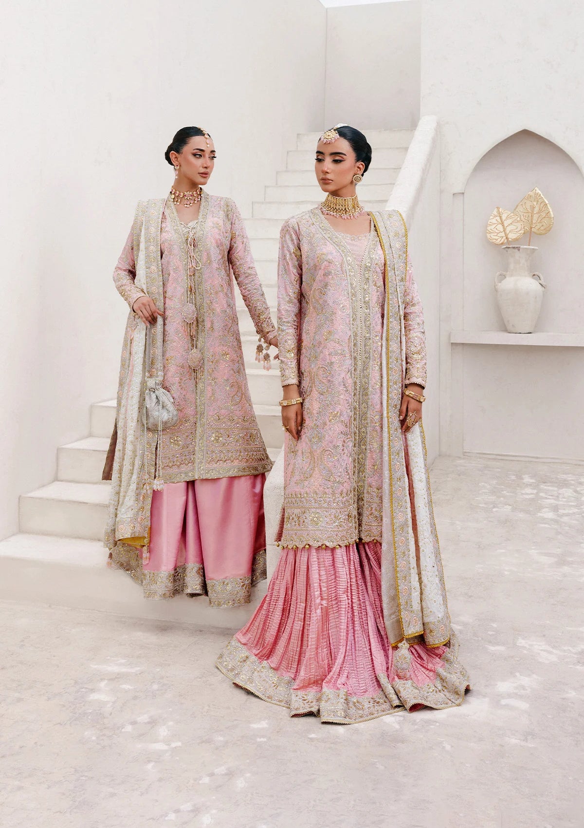 Refined katan silk ensemble with embroidered yoke, embellished borders, masoori silk pants, and a medium silk dupatta. Styled as open-front long shirt with crushed gharara or sharara.