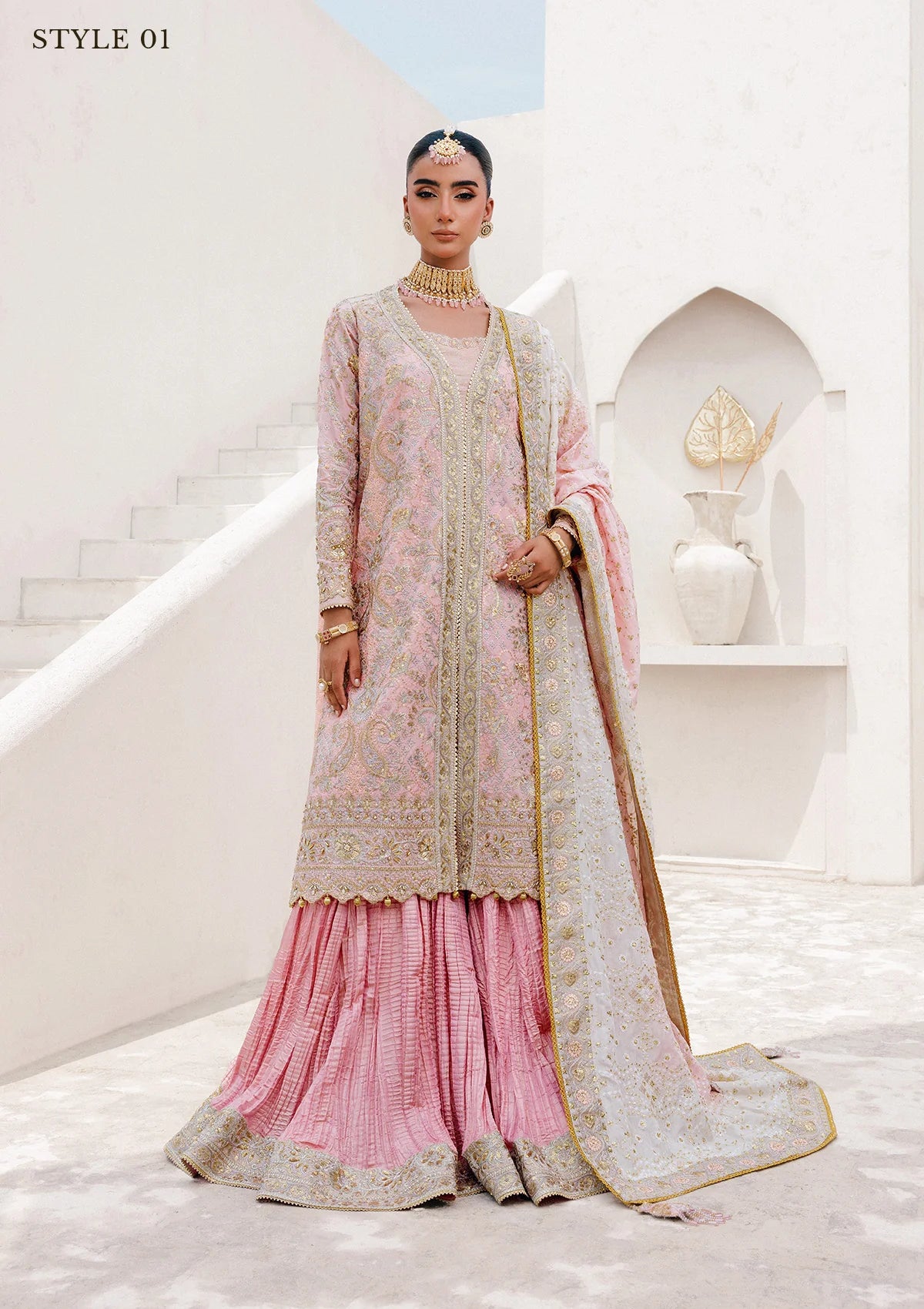 Refined katan silk ensemble with embroidered yoke, embellished borders, masoori silk pants, and a medium silk dupatta. Styled as open-front long shirt with crushed gharara or sharara.