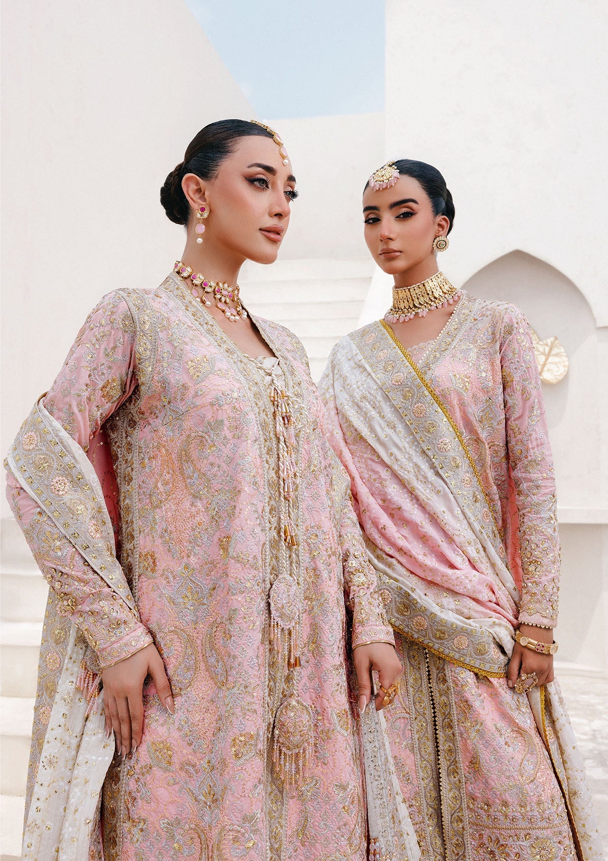Refined katan silk ensemble with embroidered yoke, embellished borders, masoori silk pants, and a medium silk dupatta. Styled as open-front long shirt with crushed gharara or sharara.
