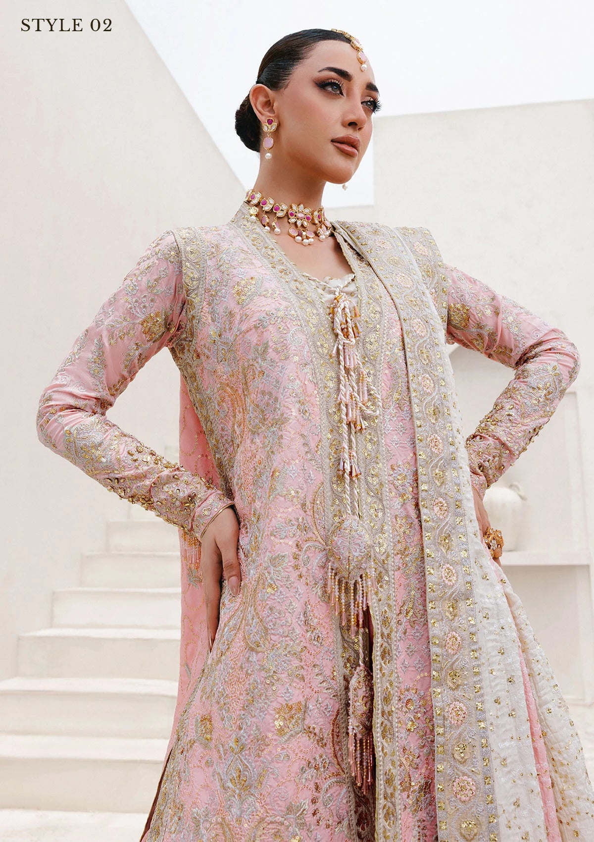 Refined katan silk ensemble with embroidered yoke, embellished borders, masoori silk pants, and a medium silk dupatta. Styled as open-front long shirt with crushed gharara or sharara.