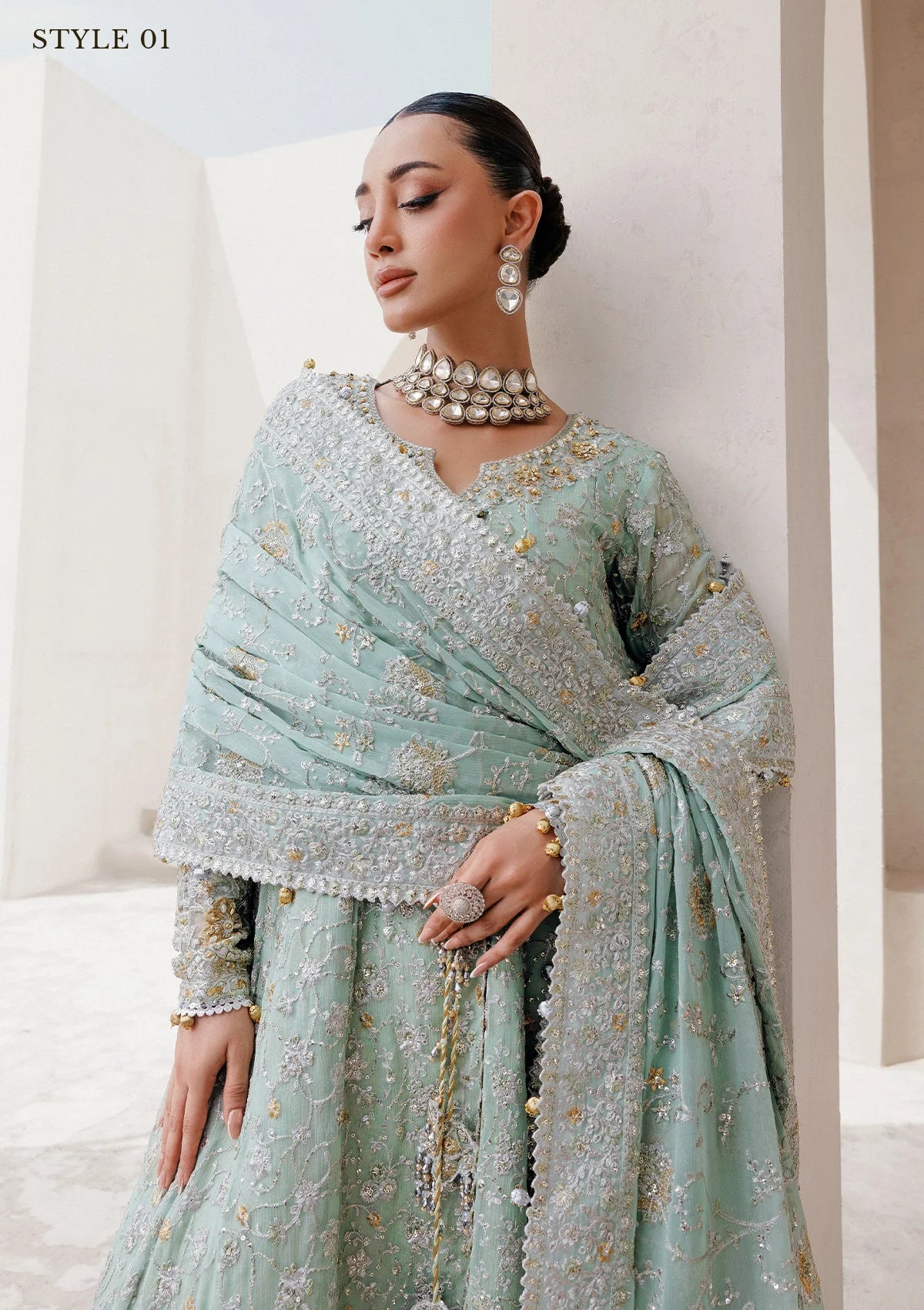 Elegant embroidered chiffon ensemble with embellished organza neckline, rich borders, jamawar pants, and chiffon dupatta. Styled as angrakha with skirt or kalidar open front with farshi gharara.