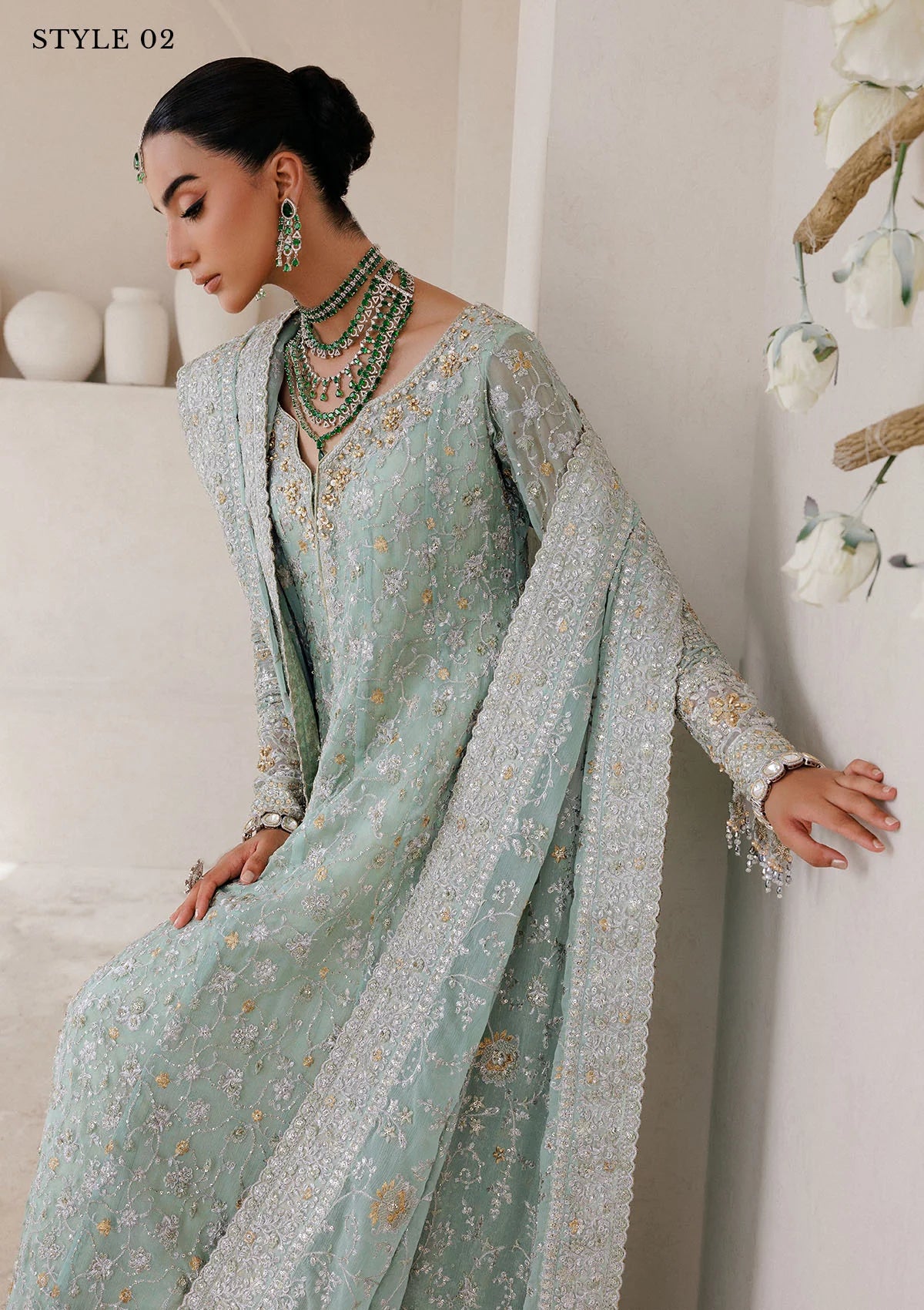 Elegant embroidered chiffon ensemble with embellished organza neckline, rich borders, jamawar pants, and chiffon dupatta. Styled as angrakha with skirt or kalidar open front with farshi gharara.