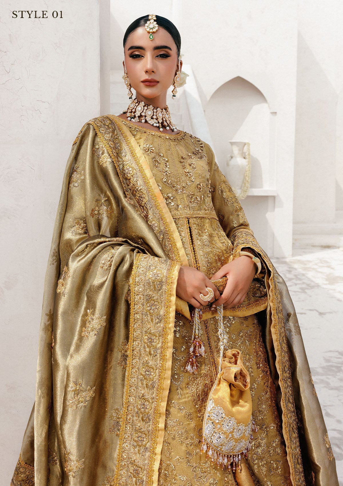 Graceful zari net ensemble with embellished bodice, tissue neckline and borders, masoori silk pants, and an embroidered tissue dupatta. Styled as open-front with skirt or long shirt with sharara.
