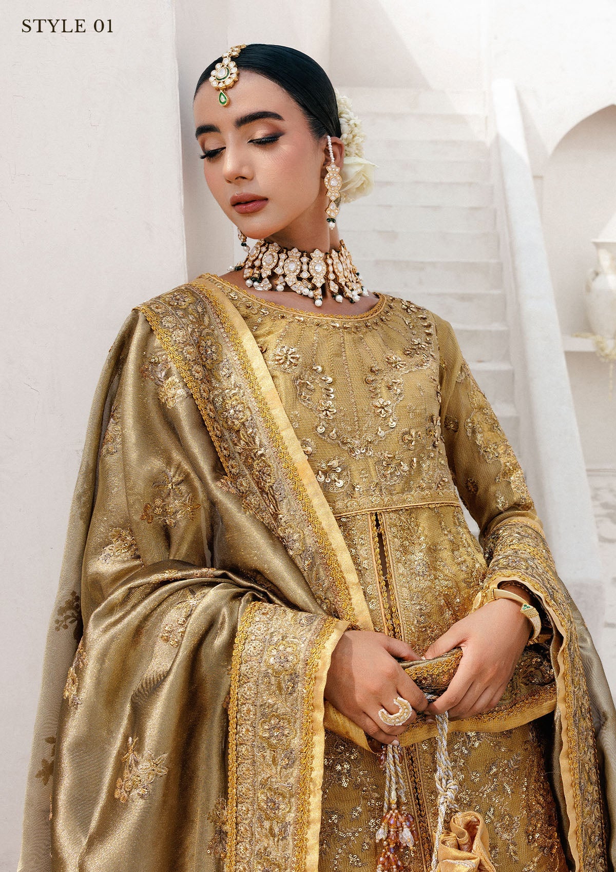 Graceful zari net ensemble with embellished bodice, tissue neckline and borders, masoori silk pants, and an embroidered tissue dupatta. Styled as open-front with skirt or long shirt with sharara.