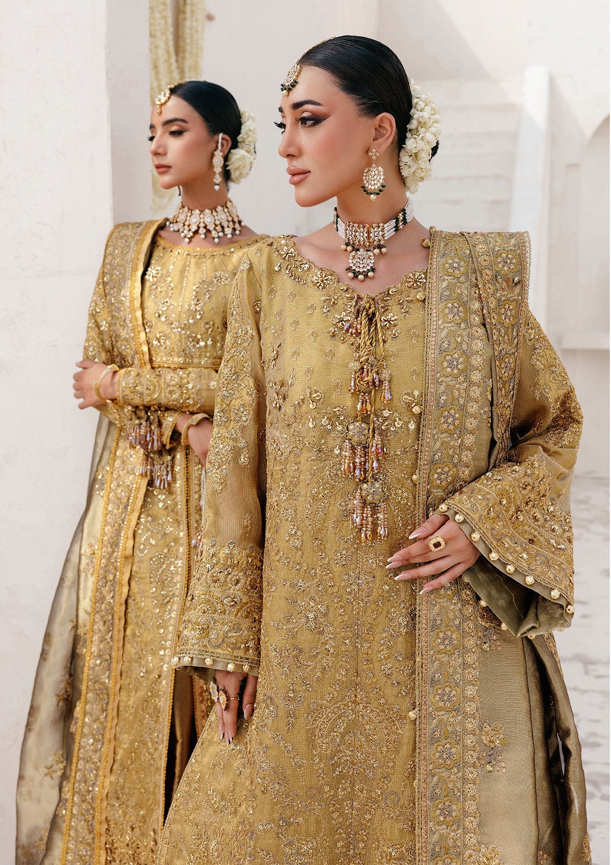 Graceful zari net ensemble with embellished bodice, tissue neckline and borders, masoori silk pants, and an embroidered tissue dupatta. Styled as open-front with skirt or long shirt with sharara.