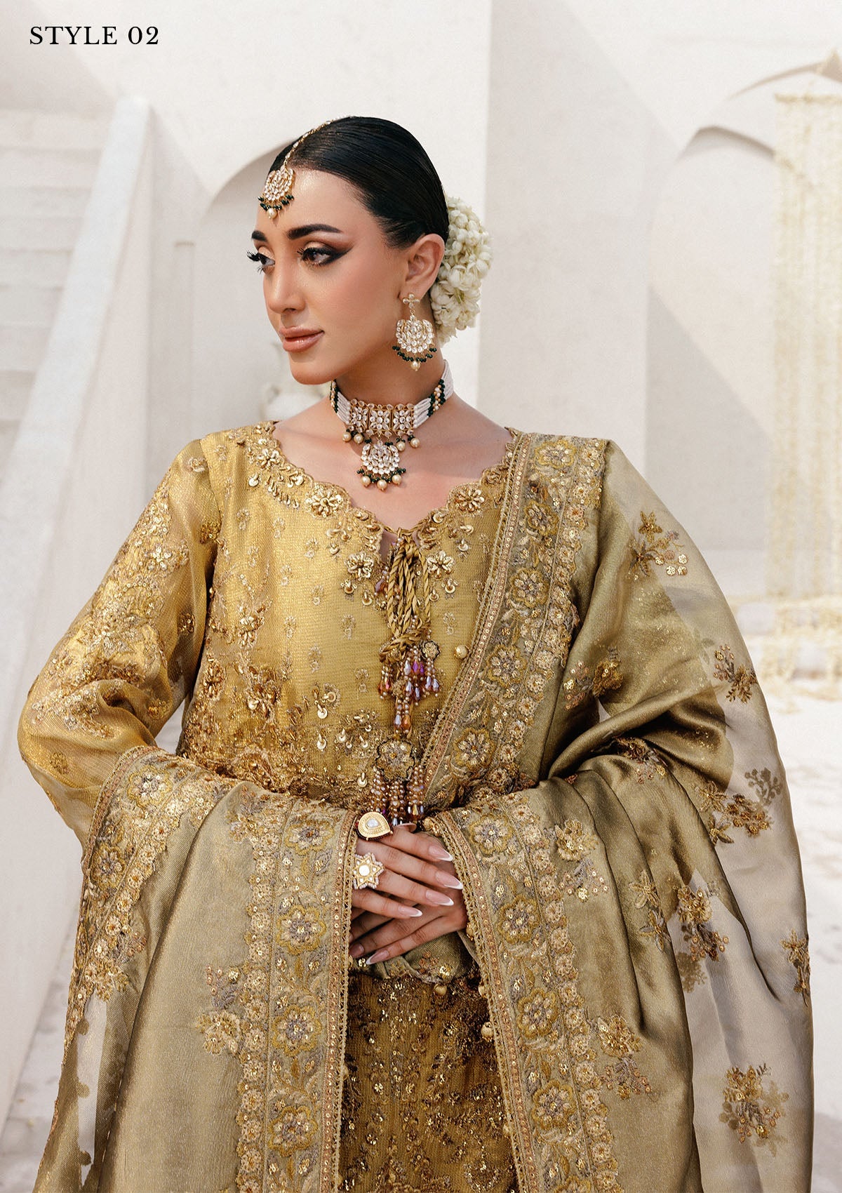 Graceful zari net ensemble with embellished bodice, tissue neckline and borders, masoori silk pants, and an embroidered tissue dupatta. Styled as open-front with skirt or long shirt with sharara.