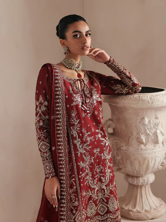 Elegant raw silk dress featuring intricate embroidered and sequined panels, borders, and chiffon dupatta. Includes organza accents and dyed silk trouser.