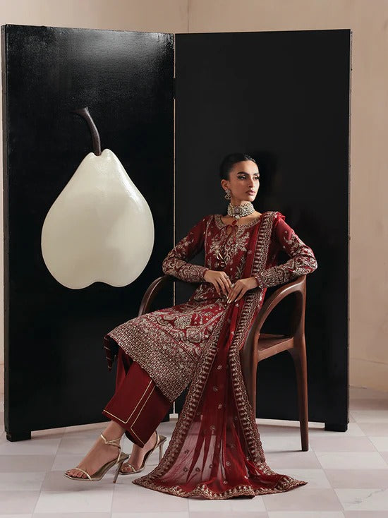 Elegant raw silk dress featuring intricate embroidered and sequined panels, borders, and chiffon dupatta. Includes organza accents and dyed silk trouser.