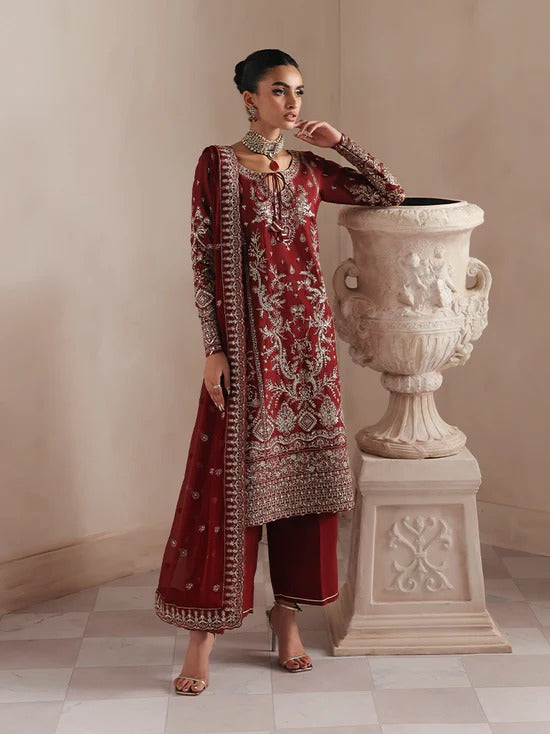 Elegant raw silk dress featuring intricate embroidered and sequined panels, borders, and chiffon dupatta. Includes organza accents and dyed silk trouser.