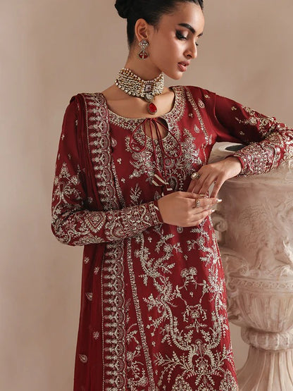 Elegant raw silk dress featuring intricate embroidered and sequined panels, borders, and chiffon dupatta. Includes organza accents and dyed silk trouser.