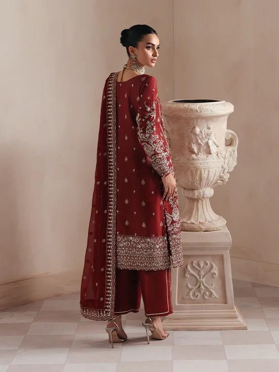 Elegant raw silk dress featuring intricate embroidered and sequined panels, borders, and chiffon dupatta. Includes organza accents and dyed silk trouser.