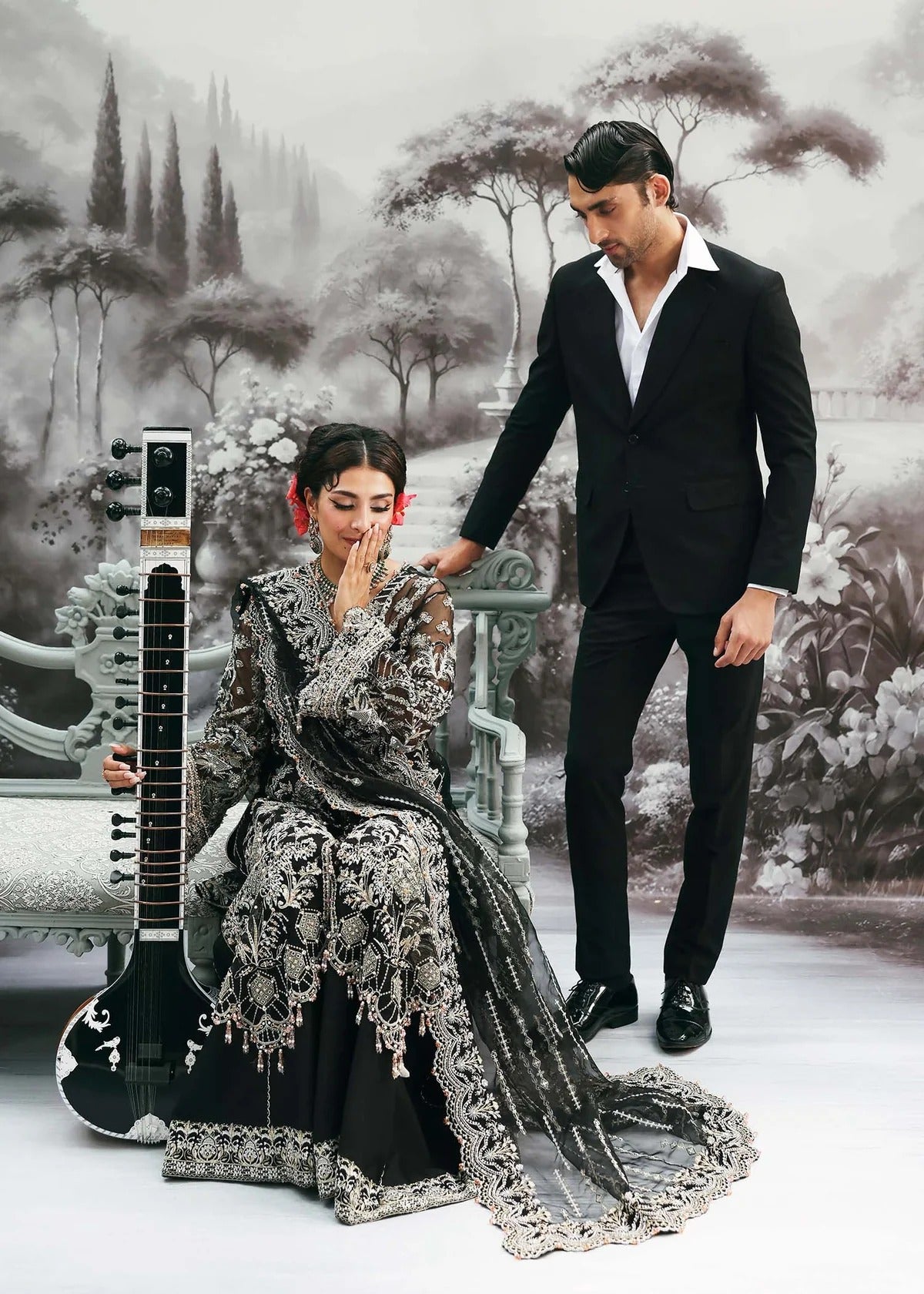 Majestic onyx noir suit with hand-embellished organza panels, refined borders, embroidered dupatta, and sleek trouser for timeless evening elegance.