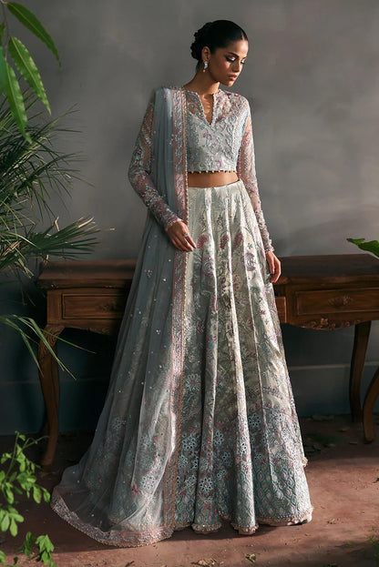 Elegant aqua net suit with embroidered panels, rose pink zari borders, and raw silk trouser for a refined festive and formal look.