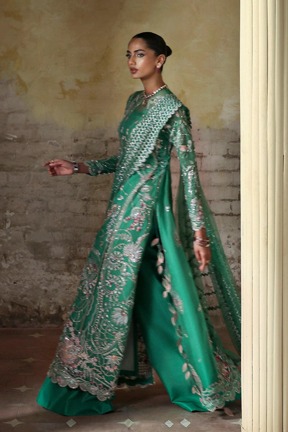 Shop this elegant Mazari Green unstitched suit with embroidered organza panels, hand embellishments, 3D floral details, silk trouser & net dupatta.