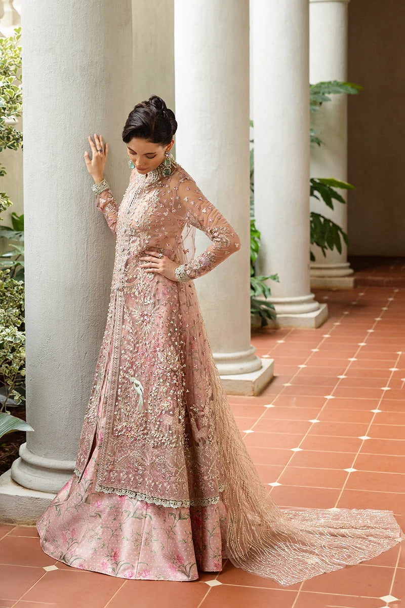 Elegant coral pink lehenga with embroidered net shirt, sequined dupatta, hand embellishments, and handmade tassels for a luxurious festive look.