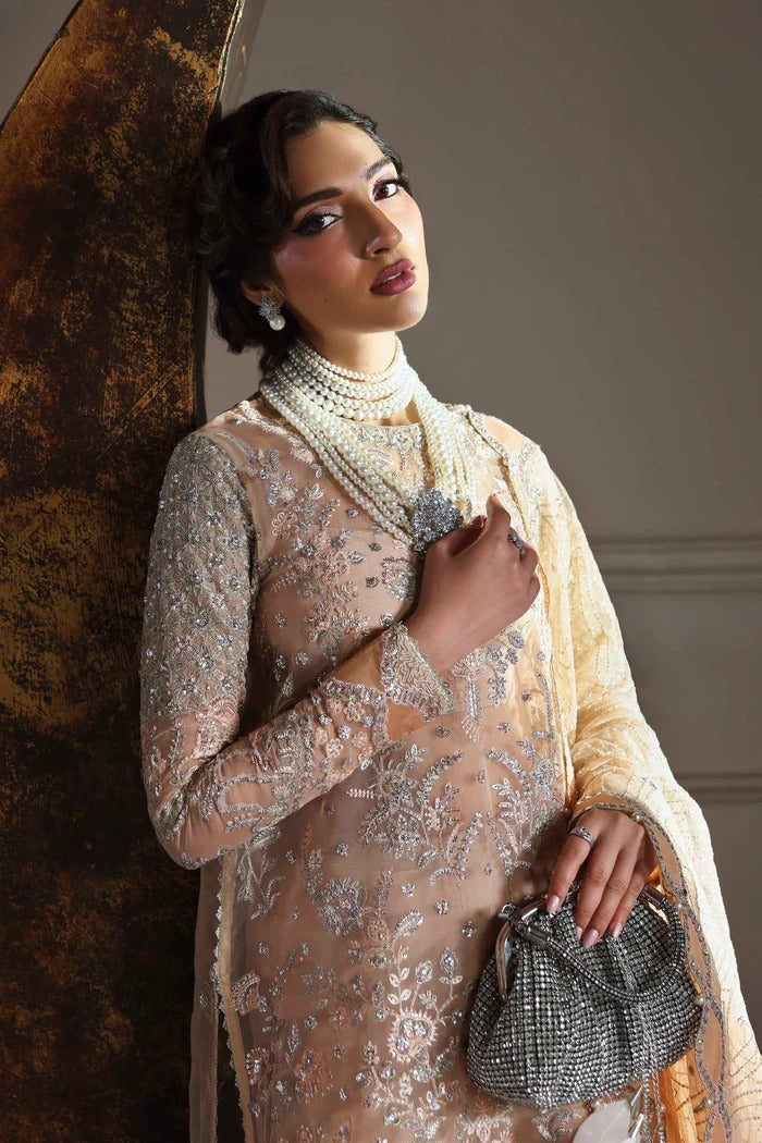 Elegant organza suit featuring embroidered front, back, sleeves, dupatta & trouser with borders, paired with silk inner—crafted for timeless grace.