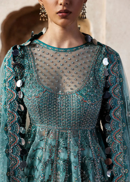 Dreamy ice blue net pishwas with sequin embroidery, silk lehnga, and chiffon dupatta. Unstitched luxury outfit that radiates elegance and grace.