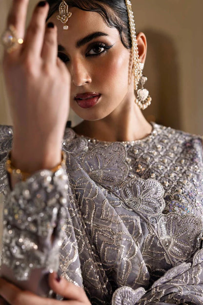 Elegant organza outfit with hand-embellished blouse, panels, sleeves, dupatta & raw silk trouser—crafted for timeless beauty and refined style.