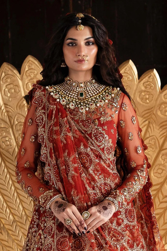 Elegant net dress with hand-embellished panels, blouse, sleeves & dupatta, paired with raw silk inner—crafted for refined beauty and timeless charm.
