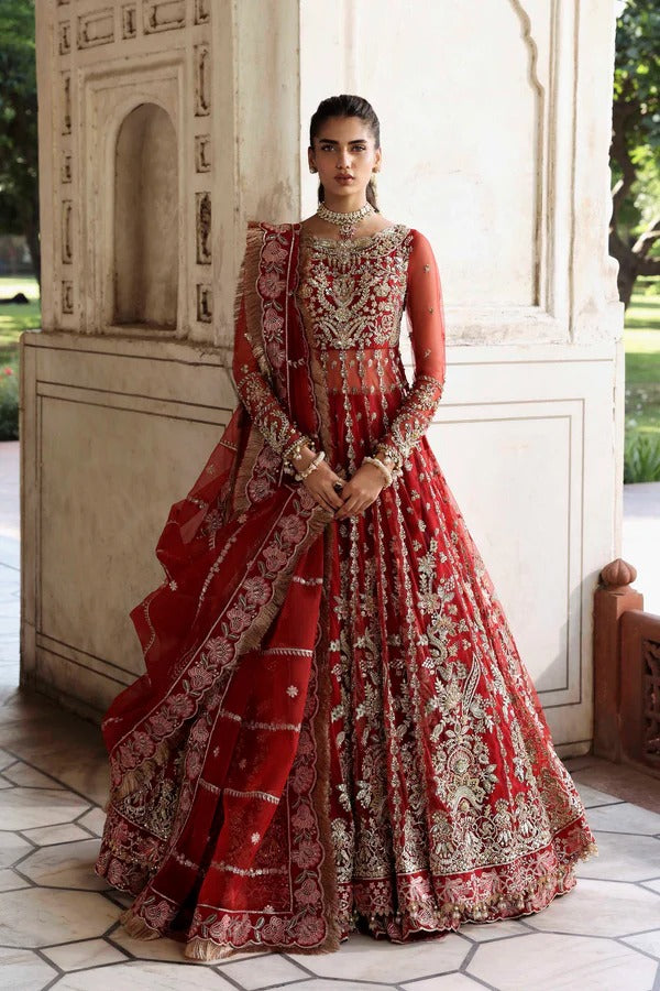 This stunning net outfit features hand-embellished panels, embroidered sleeves, and an organza dupatta with lehenga border—perfect for formal festive wear.