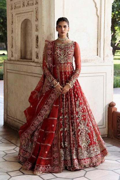 This stunning net outfit features hand-embellished panels, embroidered sleeves, and an organza dupatta with lehenga border—perfect for formal festive wear.