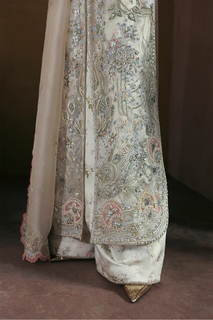 Elegant Opal White suit with embroidered organza panels, hand embellishments, silk trouser, and organza dupatta with delicate motifs.