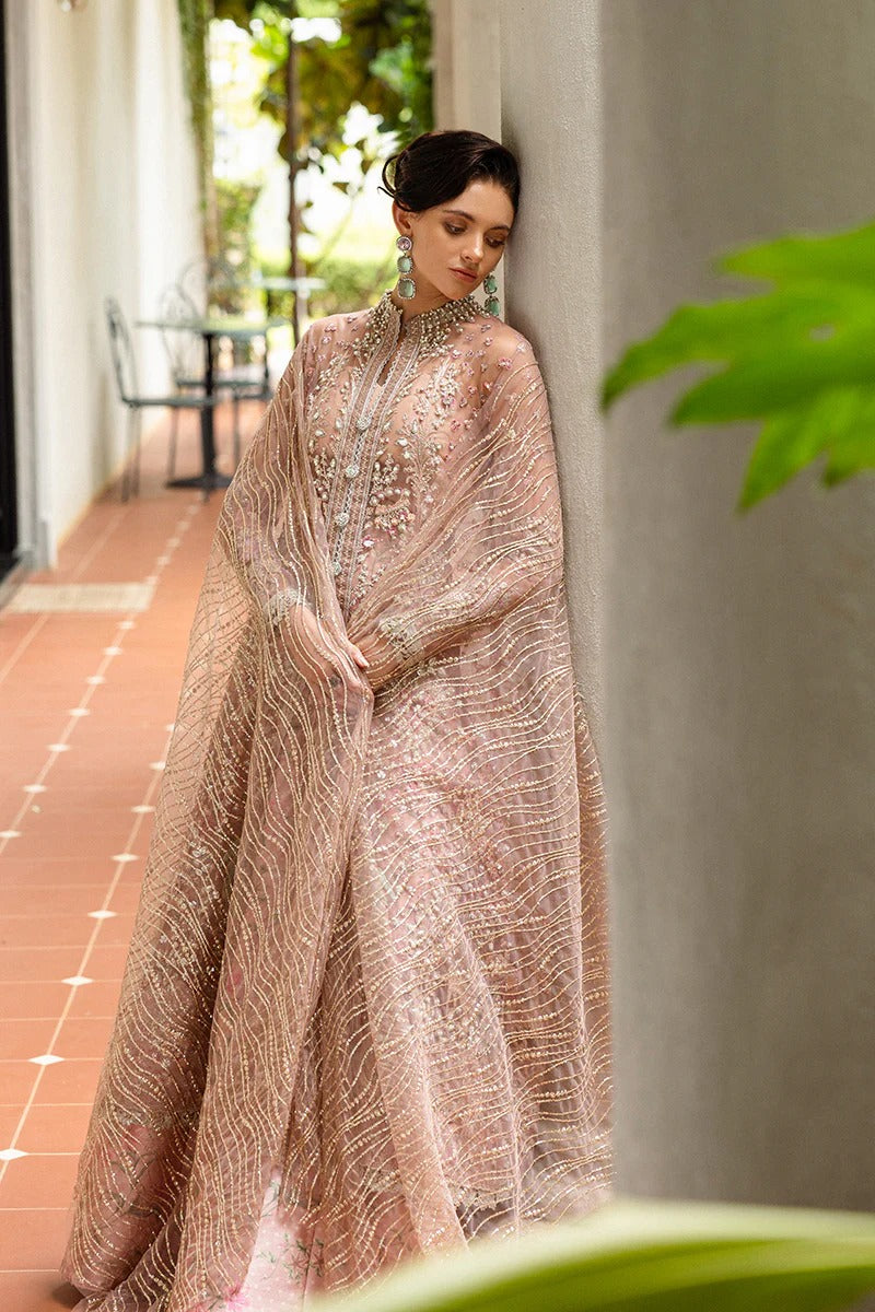 Elegant coral pink lehenga with embroidered net shirt, sequined dupatta, hand embellishments, and handmade tassels for a luxurious festive look.