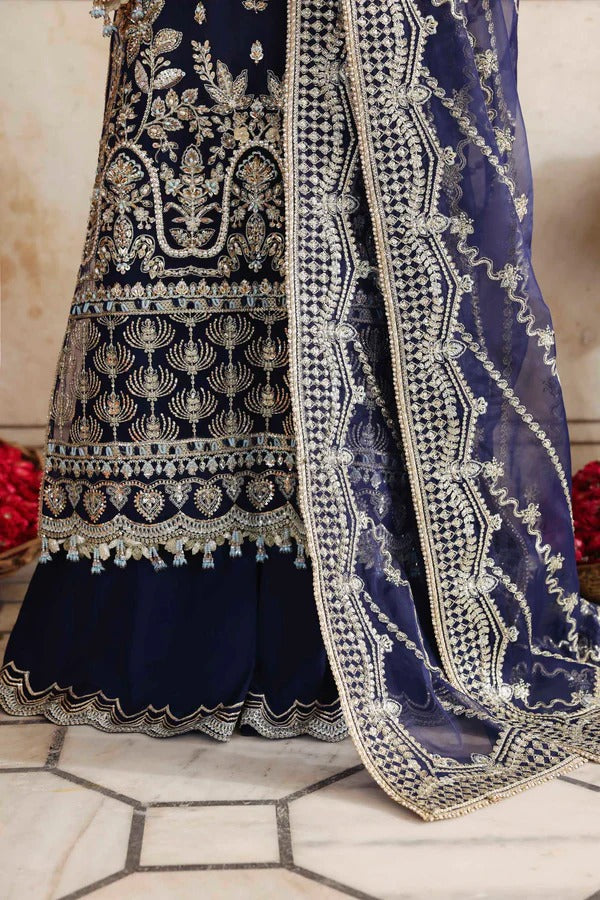 A luxurious organza outfit featuring hand-embellished front, sleeves, and borders. Comes with an embroidered dupatta and raw silk trouser for a graceful formal look.