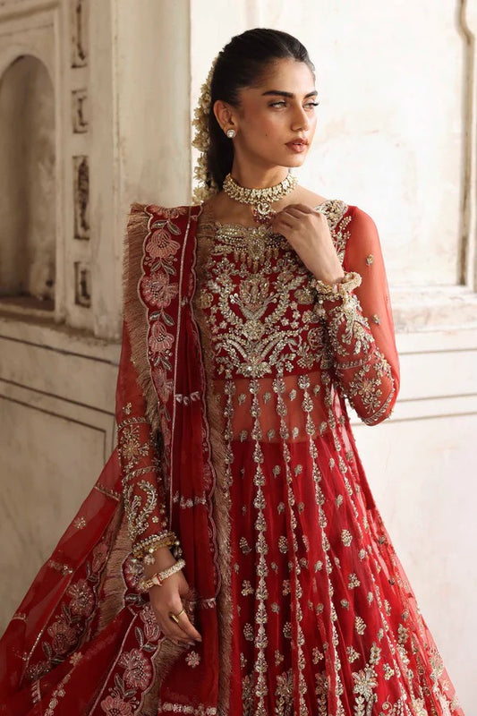 This stunning net outfit features hand-embellished panels, embroidered sleeves, and an organza dupatta with lehenga border—perfect for formal festive wear.