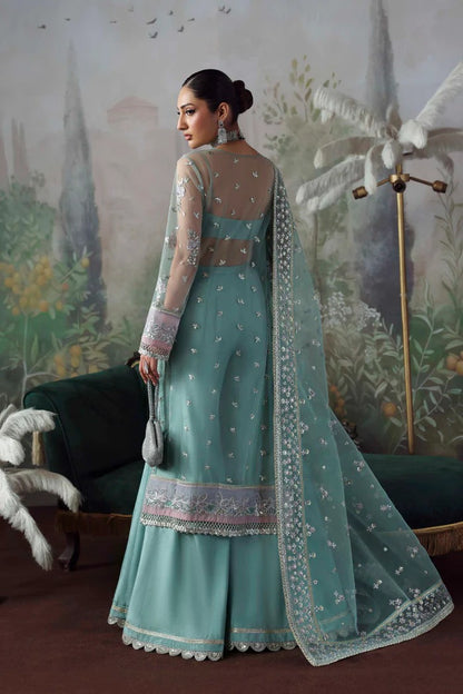 Chic net & organza suit with embroidered panels, sleeves, dupatta & borders, paired with silk inner and trouser—crafted for elegance & timeless style.