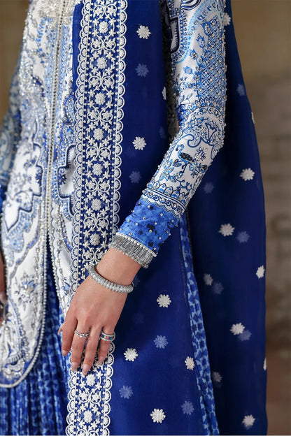 Elegant white blue printed silk suit with hand-embellished panels, embroidered dupatta,&   crushed sharara. Perfect for weddings, festive, and formal occasions.