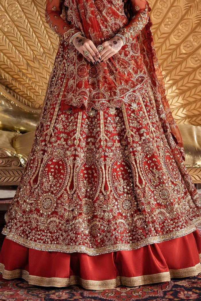 Elegant net dress with hand-embellished panels, blouse, sleeves & dupatta, paired with raw silk inner—crafted for refined beauty and timeless charm.
