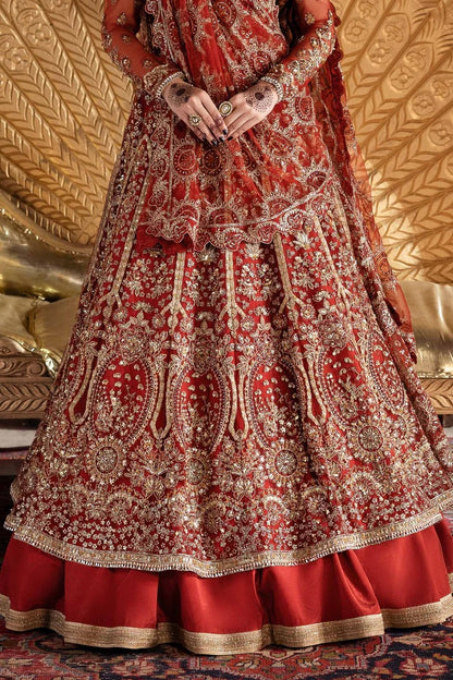 Elegant net dress with hand-embellished panels, blouse, sleeves & dupatta, paired with raw silk inner—crafted for refined beauty and timeless charm.
