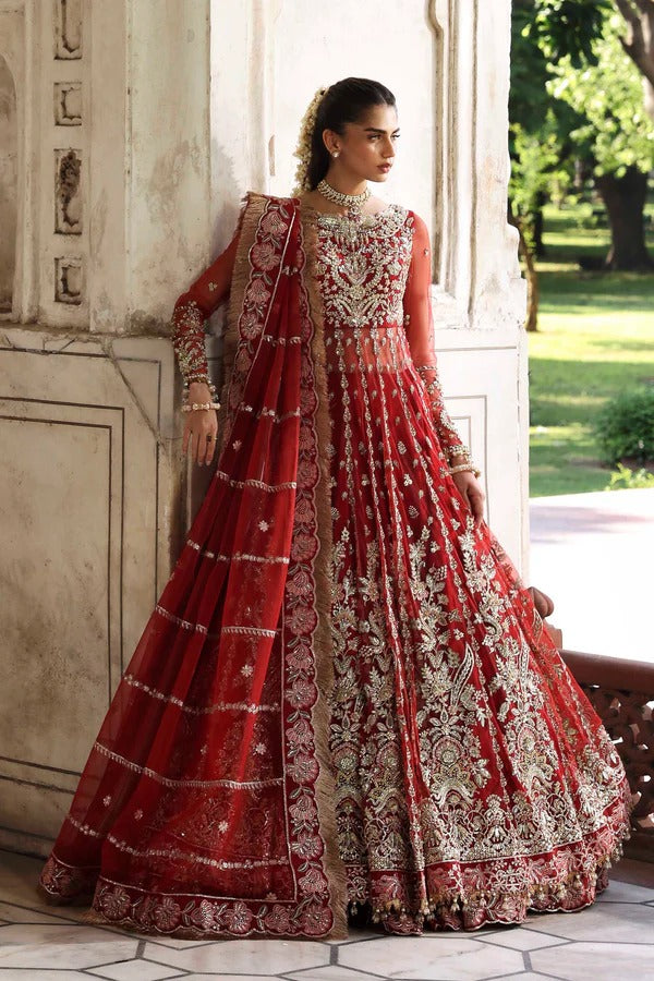 This stunning net outfit features hand-embellished panels, embroidered sleeves, and an organza dupatta with lehenga border—perfect for formal festive wear.
