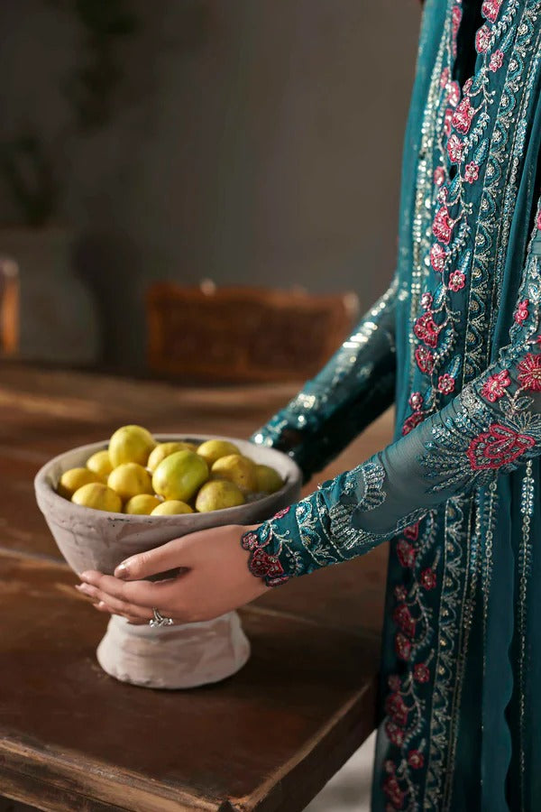 Elegant chiffon outfit featuring embroidered front, back, and sleeves with organza borders. Paired with a chiffon dupatta and raw silk trouser for a refined look.