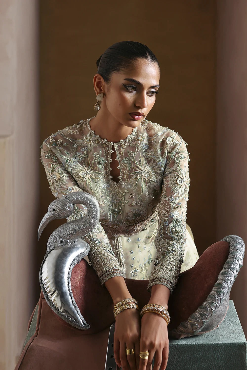 Elegant Opal White suit with embroidered organza panels, hand embellishments, silk trouser, and organza dupatta with delicate motifs.