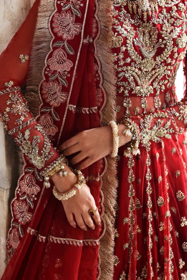 This stunning net outfit features hand-embellished panels, embroidered sleeves, and an organza dupatta with lehenga border—perfect for formal festive wear.