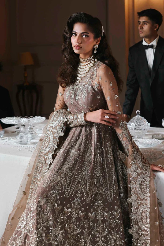Stylish net suit with embroidered panels, body, blouse, sleeves & organza dupatta with borders, paired with silk inner—crafted for timeless elegance.