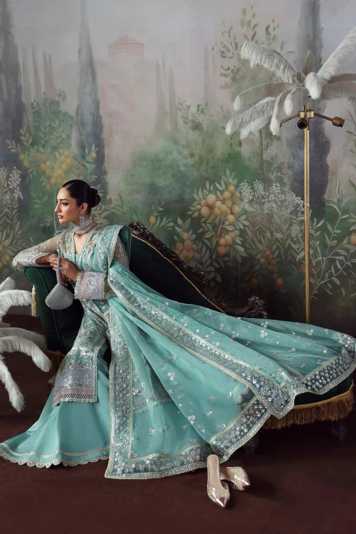Chic net & organza suit with embroidered panels, sleeves, dupatta & borders, paired with silk inner and trouser—crafted for elegance & timeless style.