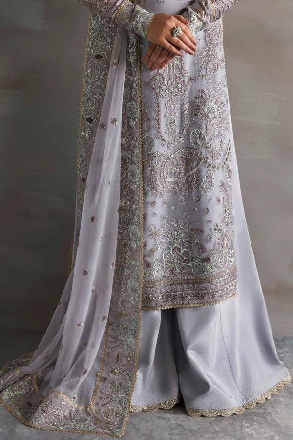 Graceful chiffon outfit with embroidered front, back, and sleeves enhanced by organza borders. Paired with a chiffon dupatta and raw silk trouser for elegance.