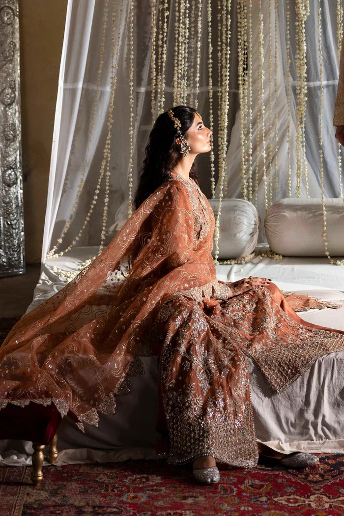 Exquisite organza suit with hand-embellished blouse, panels, sleeves, dupatta & raw silk trouser—crafted for a refined, elegant, and timeless look.