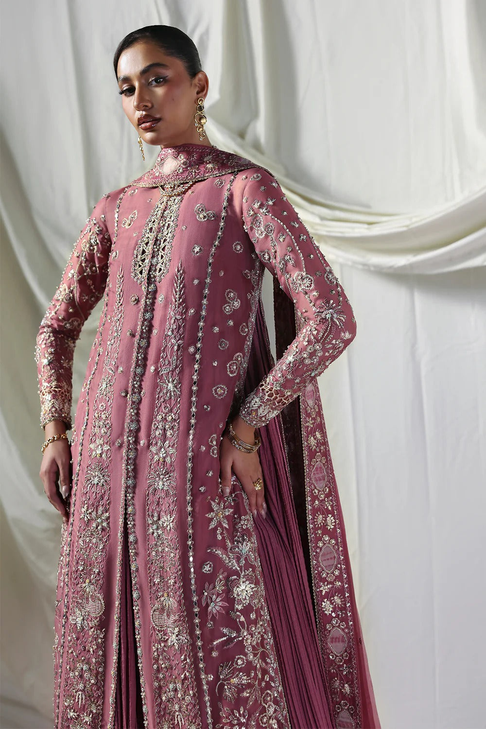 Stylish mauve silk gown featuring embroidered organza panels, embellished dupatta, and crushed inner gown. A graceful ensemble perfect for weddings & festive wear.