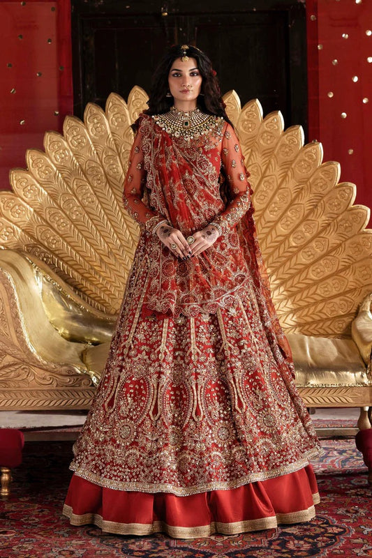 Elegant net dress with hand-embellished panels, blouse, sleeves & dupatta, paired with raw silk inner—crafted for refined beauty and timeless charm.