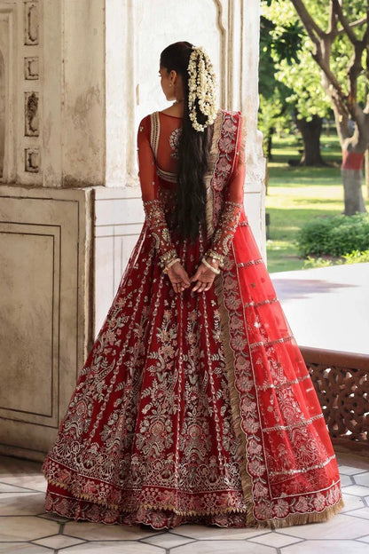 This stunning net outfit features hand-embellished panels, embroidered sleeves, and an organza dupatta with lehenga border—perfect for formal festive wear.