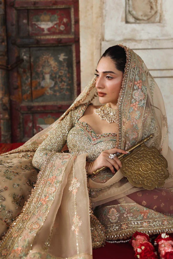 A graceful net outfit featuring hand-embellished panels, blouse, and sleeves, paired with an embroidered organza dupatta for a luxurious formal look.