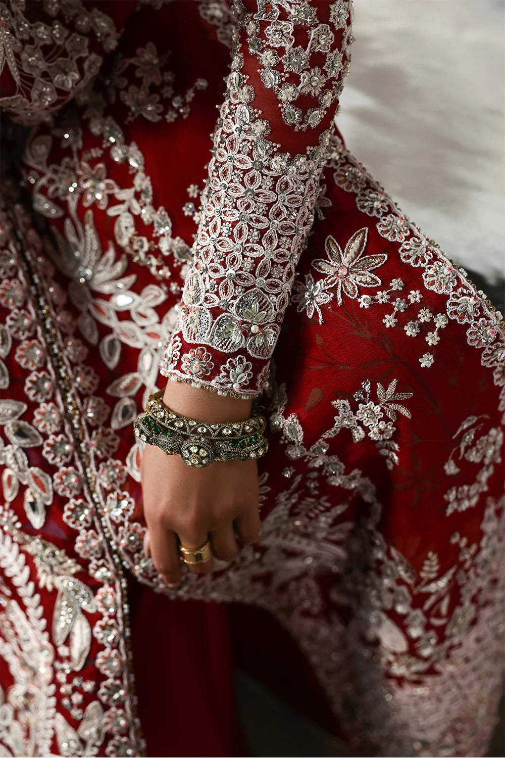 Stunning Crimson Red suit featuring embroidered organza panels, hand embellishments, silk trouser, and printed organza dupatta with elegant details.