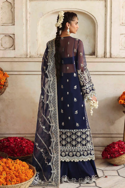 A luxurious organza outfit featuring hand-embellished front, sleeves, and borders. Comes with an embroidered dupatta and raw silk trouser for a graceful formal look.